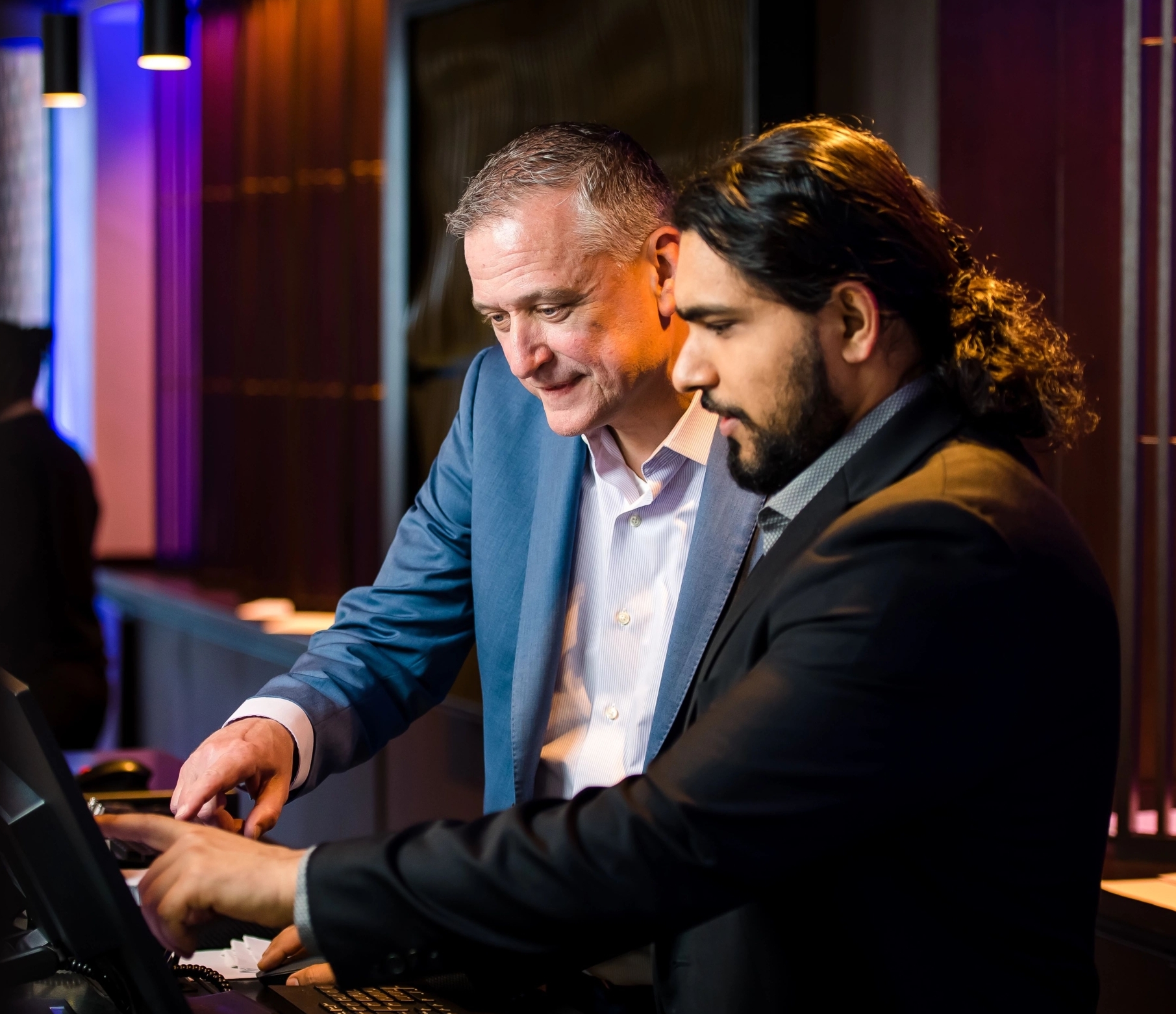 two men looking at computer