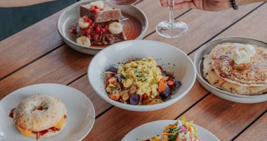 A table with plates of breakfast foods