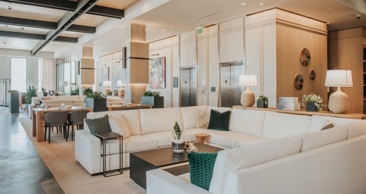 The lobby of the Bellyard hotel with large white leather couches