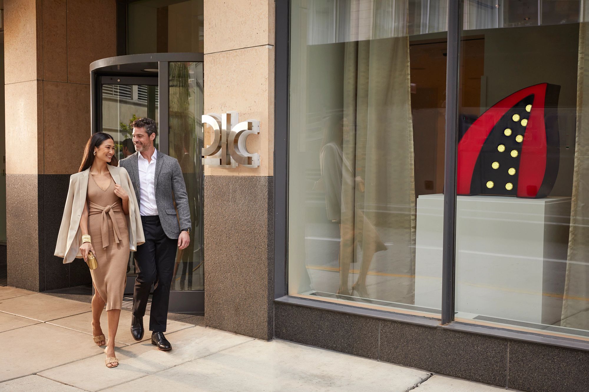 Couple walking out of the 21c Chicago hotel