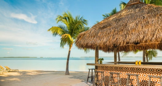 An outdoor tiki hut on the beach