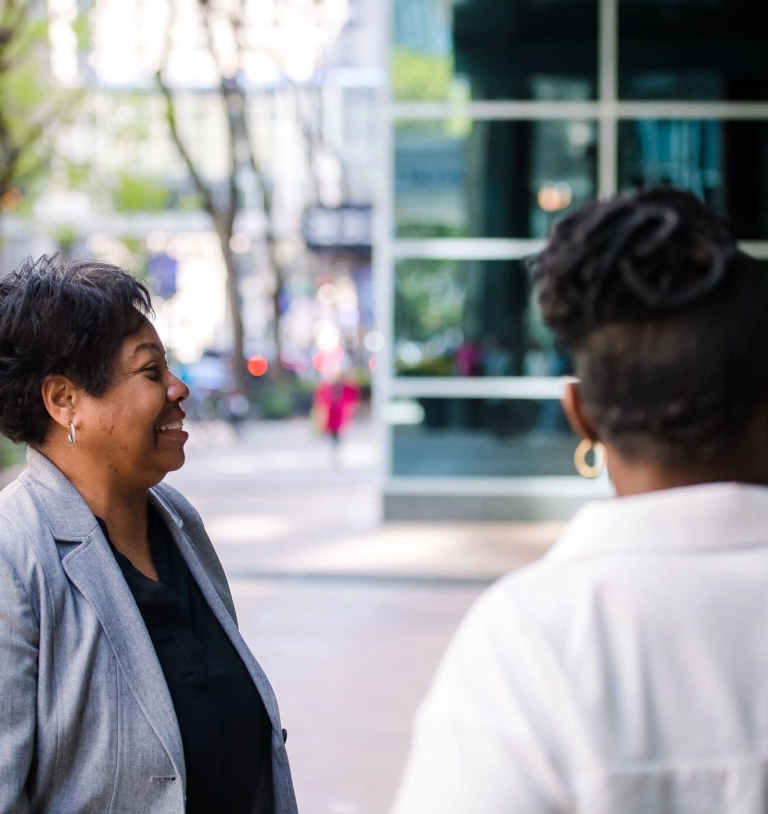 Group of three women chatting outside office