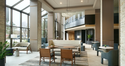 The large lobby area with floor to ceiling windows at the Marriott Overland Park hotel