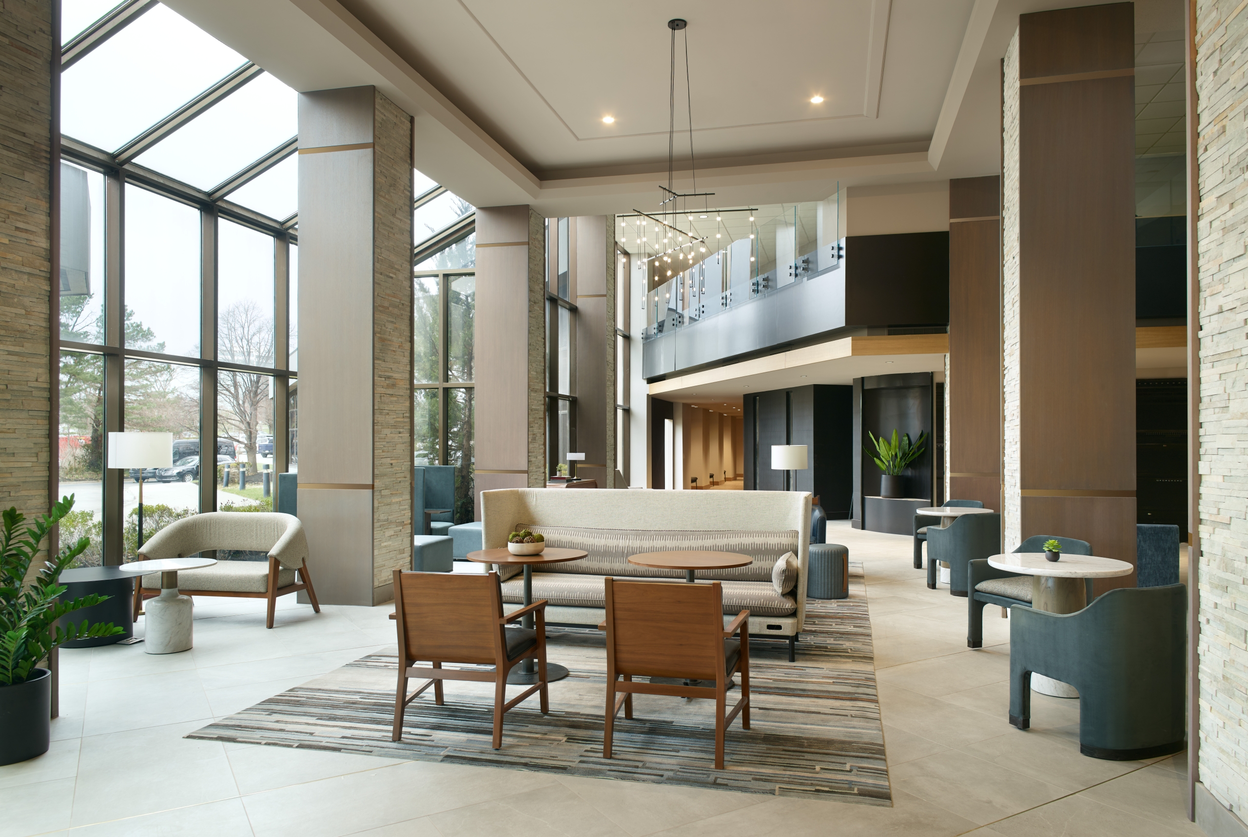 The large lobby area with floor to ceiling windows at the Marriott Overland Park hotel