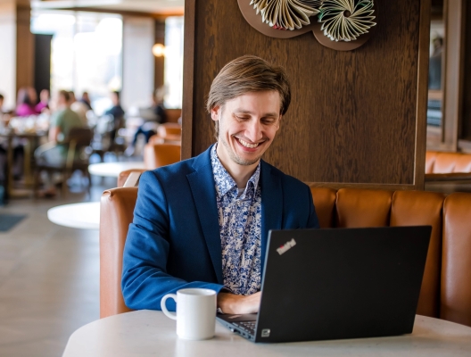 man smiling with laptop