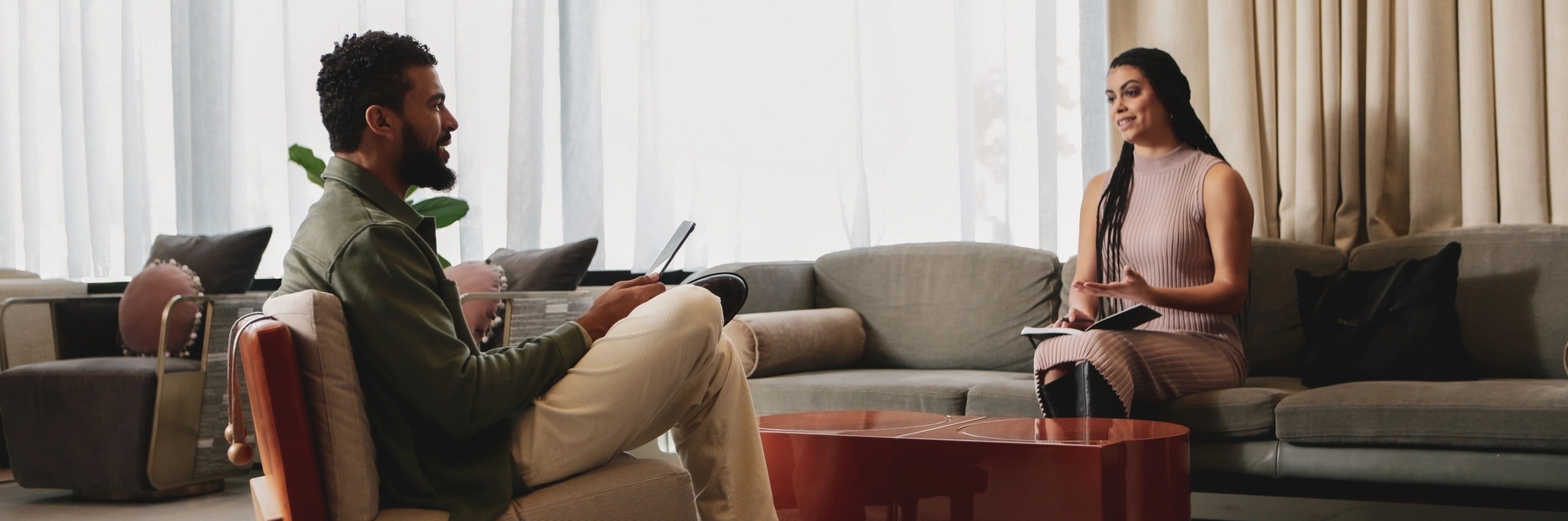 man and women talking on sofa