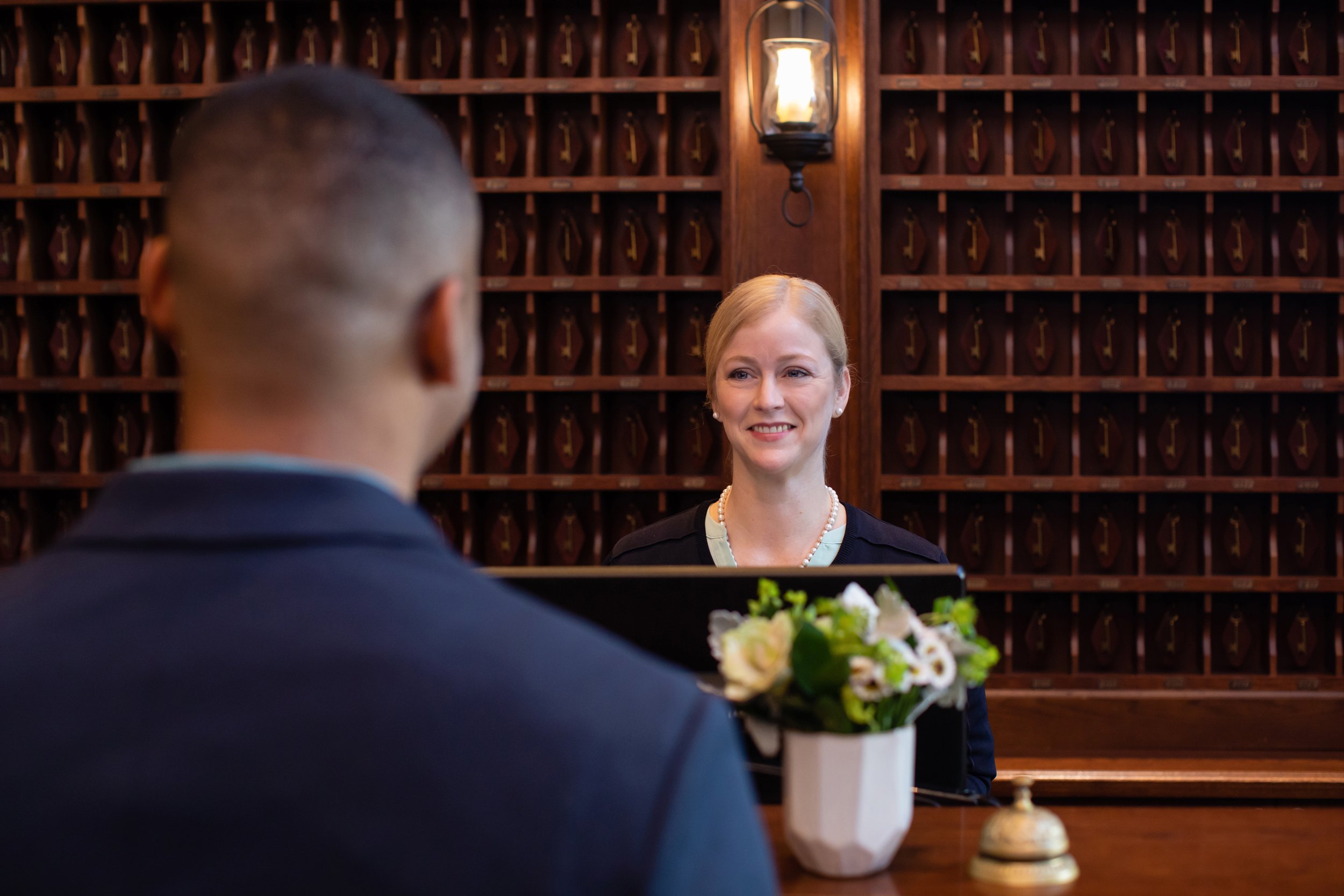 women and man at front desk