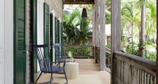 a porch deck with two rocking chairs