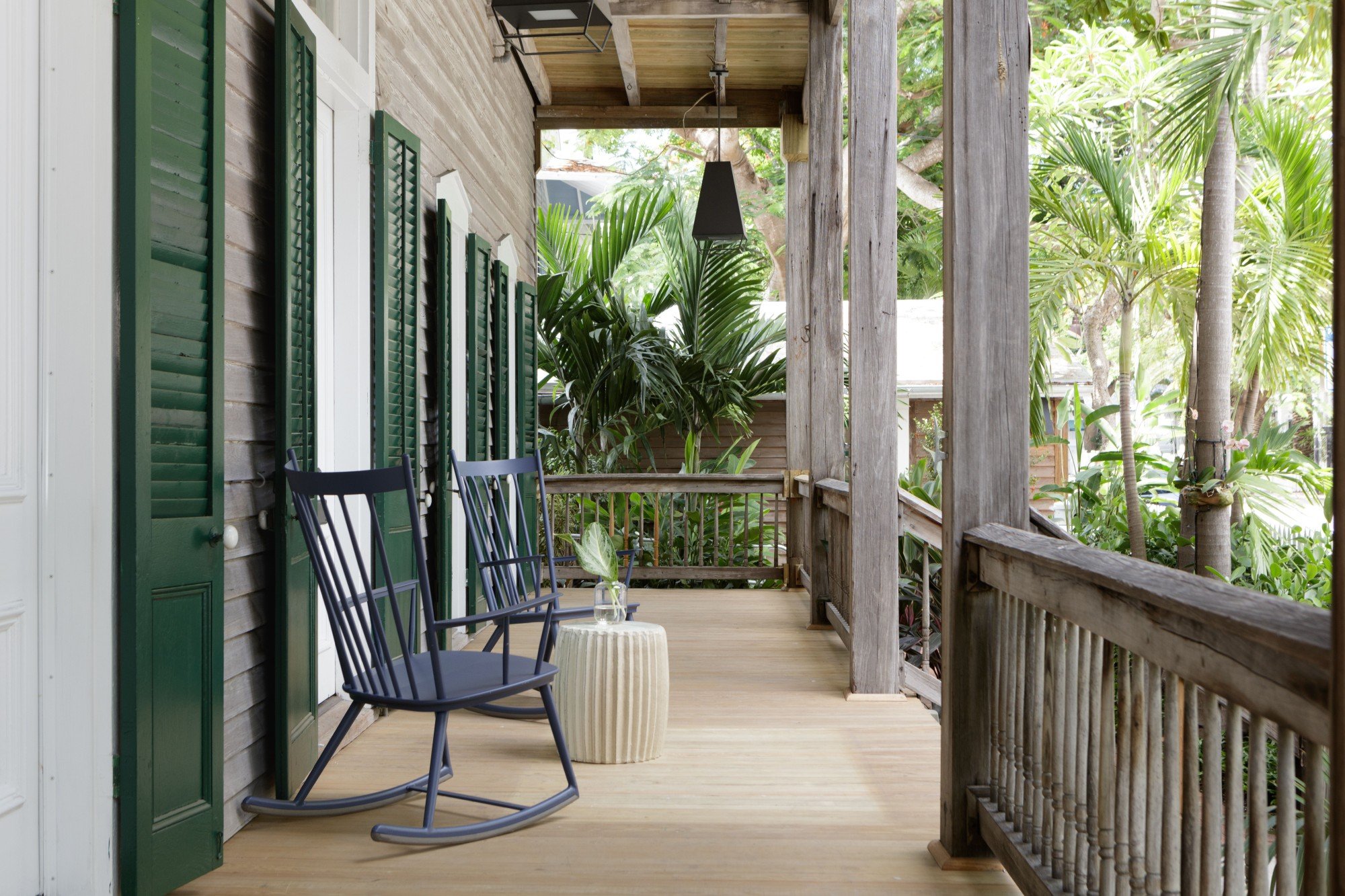 a porch deck with two rocking chairs