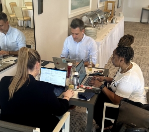 A group of people working on laptops at a table